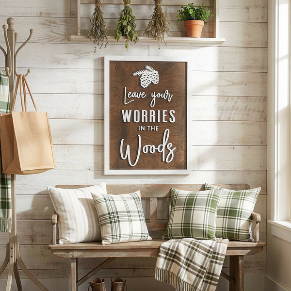 A laser cut wooden wall sign with the text "Leave your Worries in the Woods" in bold white 3D lettering.